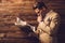 Stylish man with newspaper in rural cottage interior