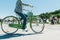 Stylish man rides a beautiful city park bike ride. Walk on a bike. Active rest. Walking bicycle