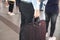 Stylish man is standing and holding black handbag while going at job in public transport