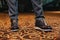 Stylish man in textured gray suit pants and brown and black brogue shoes