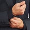 Stylish man unbuttons his sleeve business suit closeup