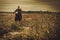 Stylish man on the vintage custom cafe racer in a field.