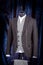 Stylish men`s gray check suit on a mannequin or dummy. Men`s Clothing. Clothing store. Shopping in boutiques