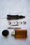 Stylish men`s rings, pen, tools, handkerchief, pomade and perfume for grooming. Metrosexual ccessories on concrete background.