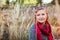 Stylish middle-aged woman chilling in autumn field. Senior lady wearing clothes and accessories. Harmony and balance