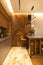 Stylish modern kitchen interior, details, studio. High bar stool, designer wood veneer panel on wall. Concept minimal, fashionable