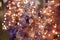 Stylish modern purple christmas tree on background of golden lights illumination bokeh, fairytale decoration. Atmospheric magic