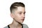 Stylish modern retro haircut side part with mid fade with parting of a schoolboy guy in a barbershop on an isolated white