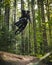 Stylish Mountain Bike Jump Trick Catching Air in Forest