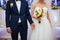 Stylish newlywed couple with bouquet at wedding reception