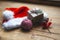 Stylish packaged Christmas gift box, Santa Claus hat and a sprig of spruce on a rustic wooden table. Atmospheric image. Merry