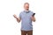 stylish pensioner man with a beard and mustache in a shirt and trousers holding a smartphone and typing a message