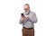 stylish pensioner man with a beard and mustache in a shirt and trousers understands the phone