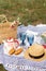 Stylish picnic on the green lawn. Fresh croissants and a teapot with tea on a bedspread near a wicker female hat. Instagram