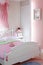 Stylish pink bedroom with double bed