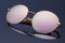 Stylish polarized reflected sunglasses on dark blue background.