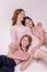 Stylish portrait of a mother with two teenage daughters. Motherhood childhood