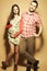 Stylish pregnancy concept: portrait of two happy hipsters husband and wife in trendy clothes shirt, dress, cardigan, jeans and