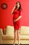 Stylish pregnant woman in red.