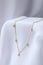 Stylish presentation of necklace on white cloth