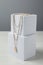 Stylish presentation of necklaces on podiums on white wooden table