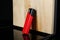 Stylish presentation of red plastic cigarette lighter near wooden surface