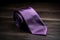 Stylish purple silk necktie on wooden board. Generate Ai