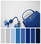 Stylish purse and perfume bottle on background, flat lay. Color of the year 2020 Classic blue