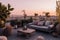 Stylish rooftop terrace with comfortable outdoor furniture, lush greenery, and panoramic city views, creating an urban oasis for