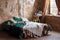 Stylish room interior with large comfortable bed. Beige and white dream catchers and feathers hanging above gypsy or hippie slyle