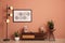 Stylish room interior with wooden cabinet, lamp and beautiful houseplants near pale pink wall