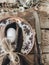 Stylish rustic Easter table setting. Natural egg, napkin, feathers, plate, cutlery on aged wood