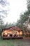 Stylish rustic restaurant wooden tent with wooden tables and chairs. Vintage design of the restaurant in the forest