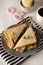 Stylish sandwich. Toasted double panini with ham, cheese fresh vegetables. Snack at work or lunch. Light background