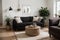 Stylish Scandic living room interior - sofa, armchair, coffee table, plants in pots, lamp, home decorations. Cozy Autumn. Modern c