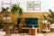 Stylish scandinavian interior of living room with design green velvet sofa, gold pouf, wooden furniture, plants, carpet, cube.