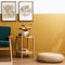 Stylish scandinavian interior of living room with design green velvet sofa, gold pouf, wooden furniture, plants, carpet, cube.