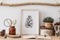Stylish and scandinavian interior of living room with mock up templates, wooden accessories, succulents, forest cones.
