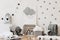 Stylish scandinavian kid room with mock up poster; toys; teddy bear; plush animal; natural pouf and children accessories.