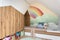 Stylish scandinavian kid room with toys, teddy bear, plush animal toys, furniture, kid accessories. Modern interior with rainbow.