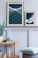 Stylish scandinavian living room interior with design grey stool, wooden console, plants, book, decoration, mock up poster frame