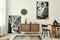 Stylish scandinavian living room interior of modern apartment with wooden commode, design table, chairs, carpet, abstract.