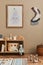 Stylish scandinavian newborn baby room with brown wooden mock up poster frame, toys, doll and child accessories. Cozy decoration.