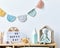 Stylish scandinavian newborn baby room with toys, plush animal, photo camera, dolls and child accessories. Cozy decoration.