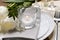 Stylish setting with cutlery, burning candle and tulips on table, closeup