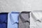 Stylish shirts on grey marble table, flat lay. Dry-cleaning service