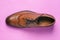 Stylish shoes on a pink background. Men`s leather shoes. Men`s fashion. Office shoes for everyday walking. Top view, close-up