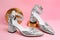 Stylish silver female shoes and decor on pink background