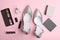 Stylish silver female shoes and decorative cosmetics on background, flat lay