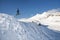 Stylish snowboarder with helmet and mask jumps from high snow slope